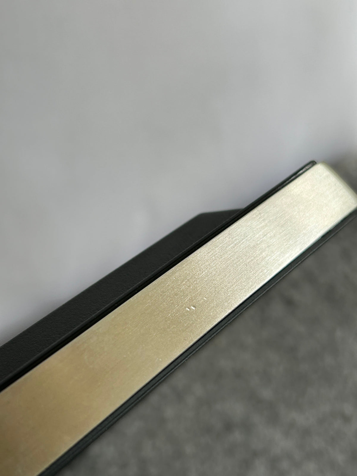 ZACK 60050Y：HOYOの壁掛け時計：金属色の側枠の細かな筋と表面状態を近くから見た拡大